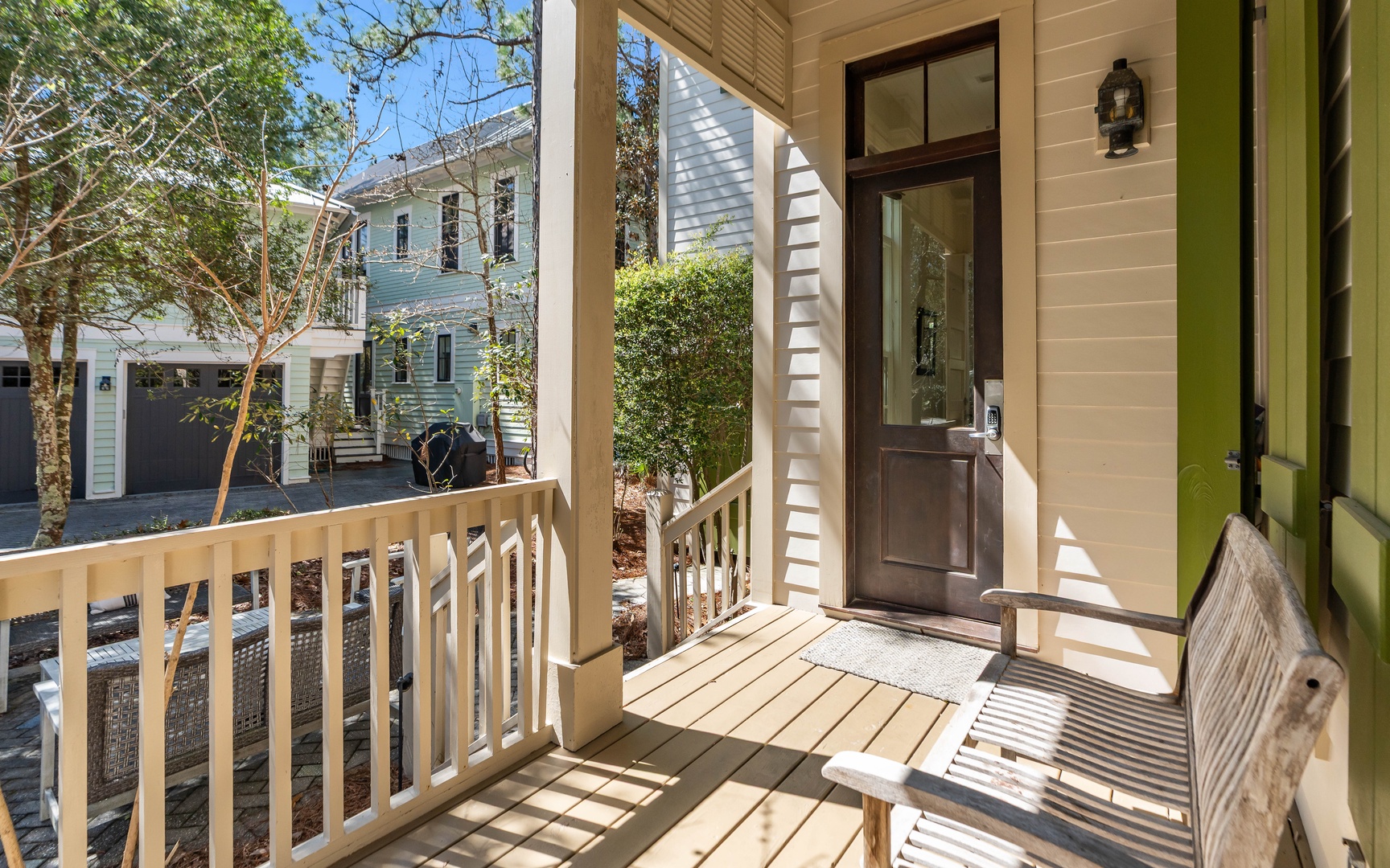 Step onto your private covered porch where morning coffee tastes better surrounded by charming neighborhood views and dappled sunlight.