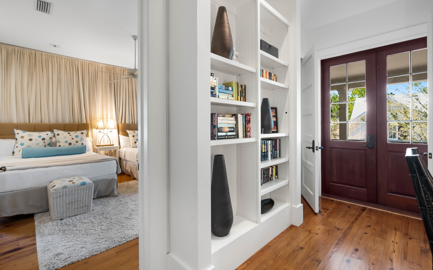 Step into your cozy bedroom featuring built-in bookshelves filled with reads for quiet evenings and warm hardwood floors throughout.