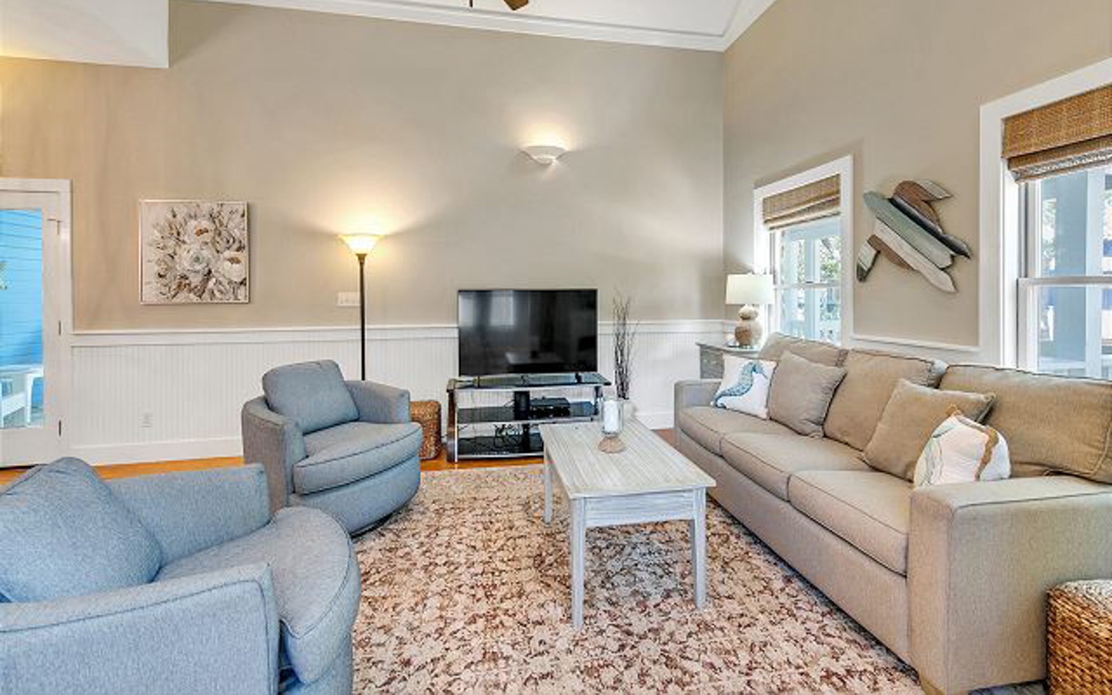 Relax in your spacious living room with plush seating, warm lighting, and modern entertainment setup—perfect for cozy evenings after exploring.