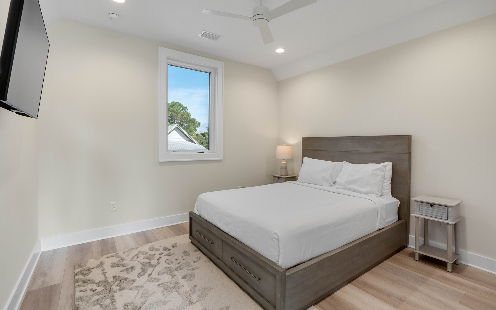 Your peaceful bedroom features crisp white linens and modern furnishings, creating the perfect retreat for restful nights.