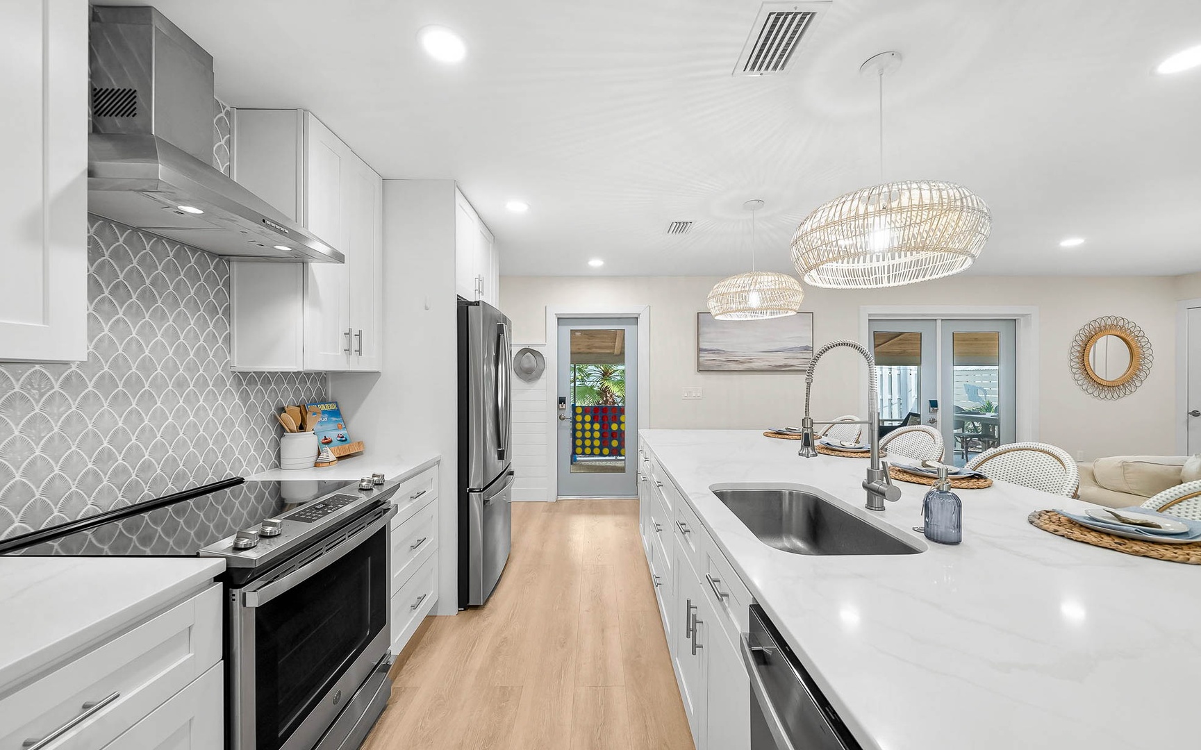 Your gourmet kitchen awaits with sleek white cabinetry, sparkling quartz countertops, and premium stainless appliances ready for culinary adventures.