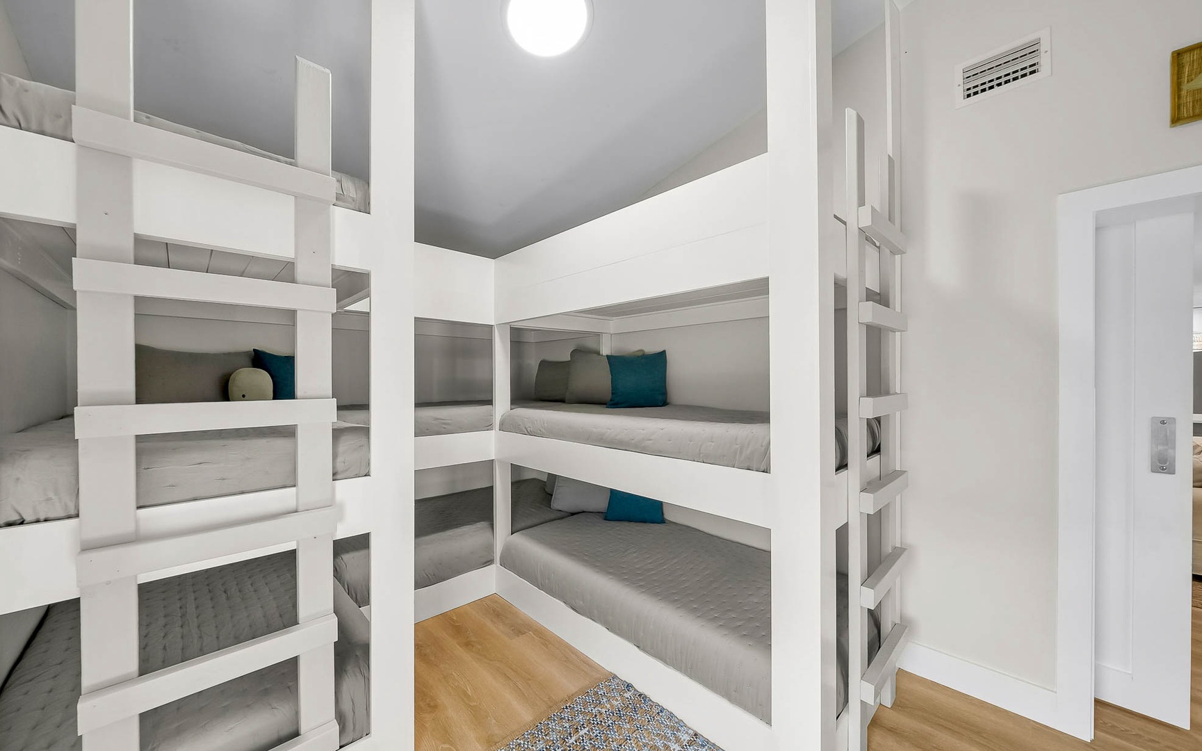 Your private bunk room features cozy built-in beds with soft linens and teal accents, perfect for restful nights.