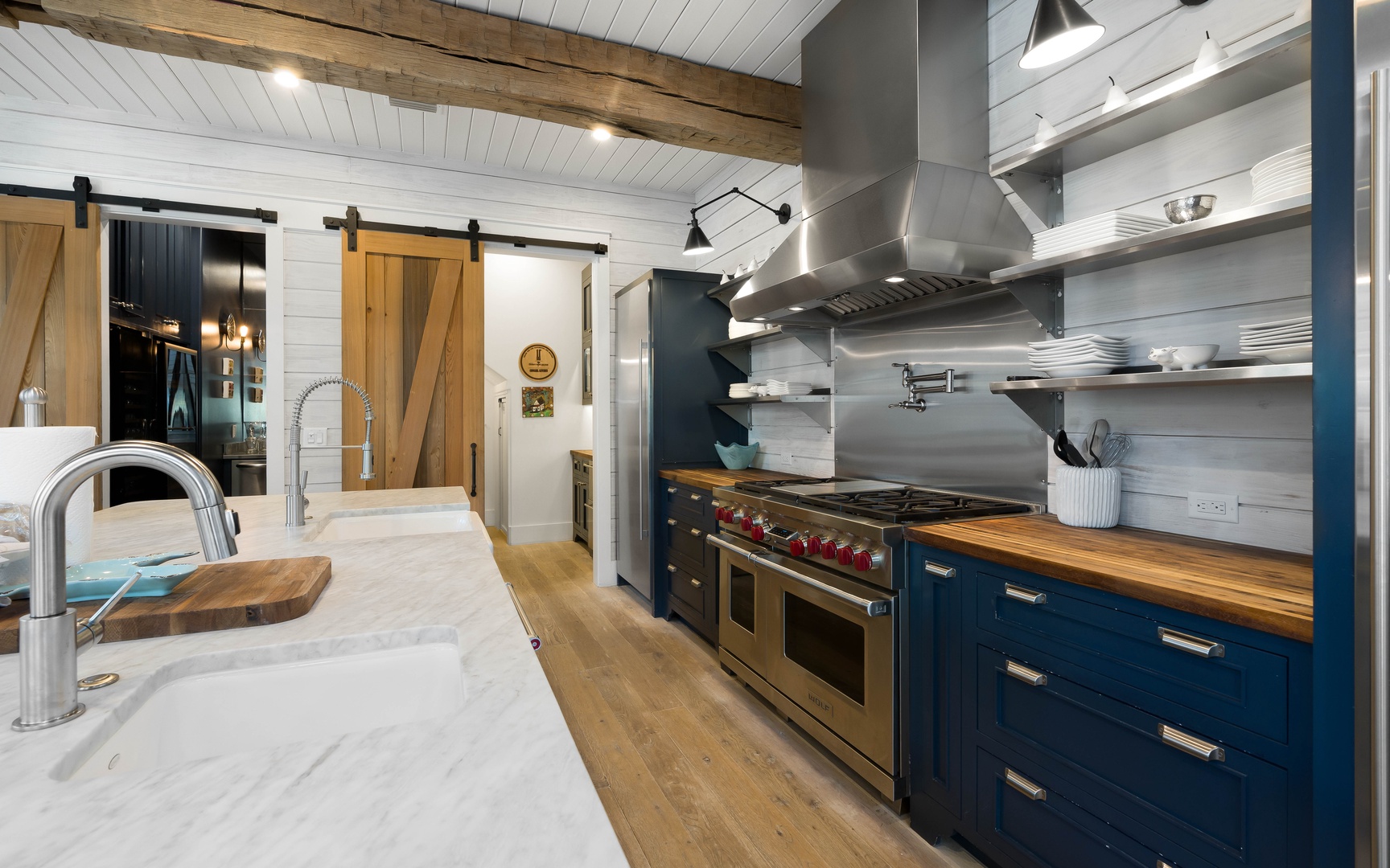 Your gourmet kitchen features professional-grade appliances, warm wood counters, and rustic beams overhead for memorable culinary adventures.