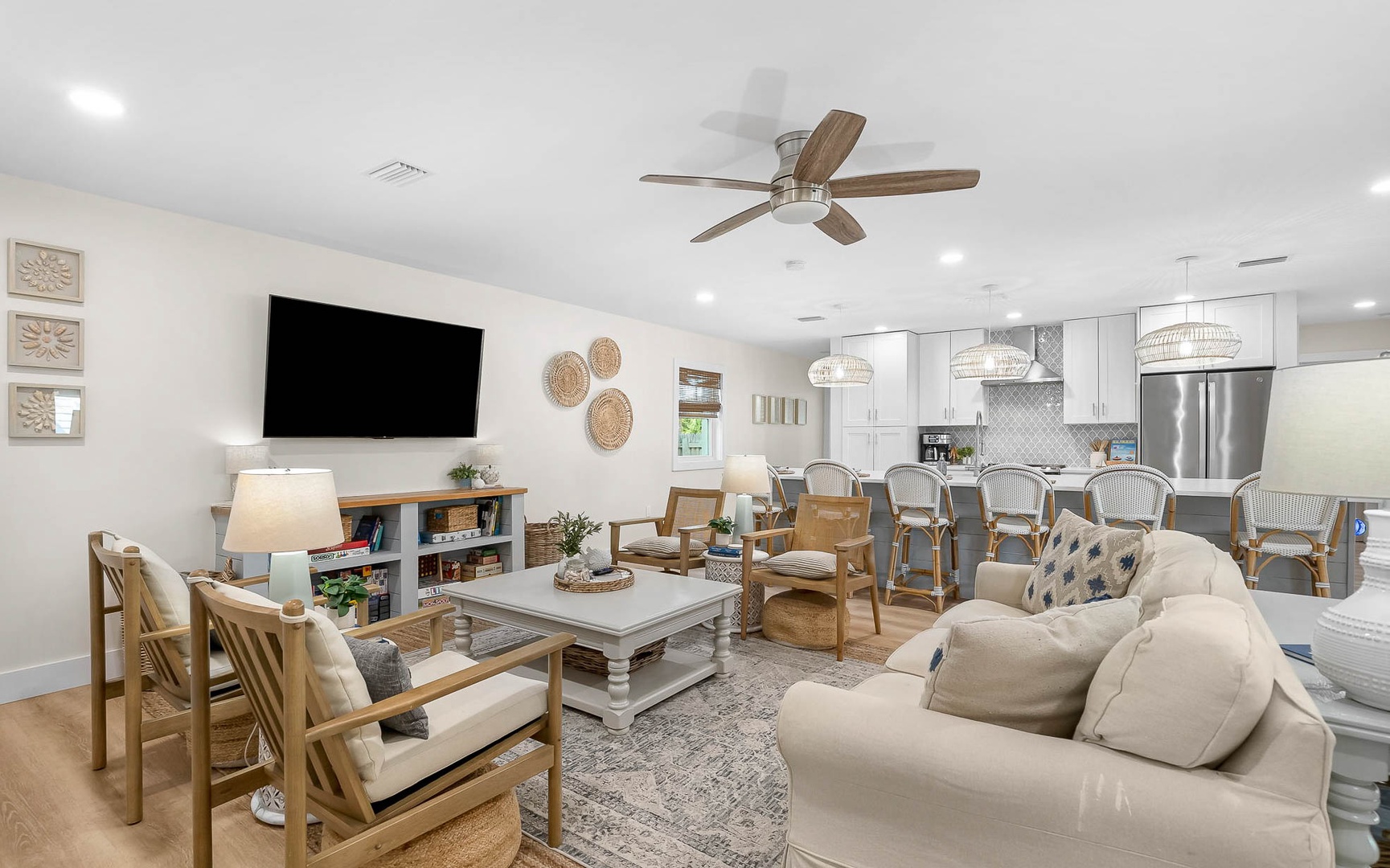 Your spacious open-concept living area welcomes you with coastal charm—plush seating, modern kitchen, and thoughtful touches creating the perfect retreat.
