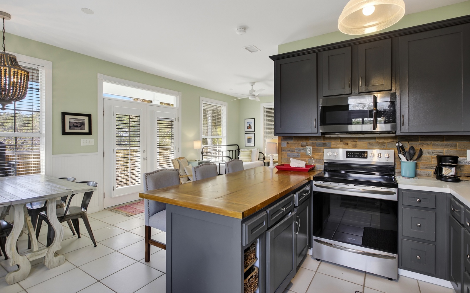 Cook memorable meals in your spacious kitchen with stainless appliances, wood countertops, and natural light streaming through French doors.