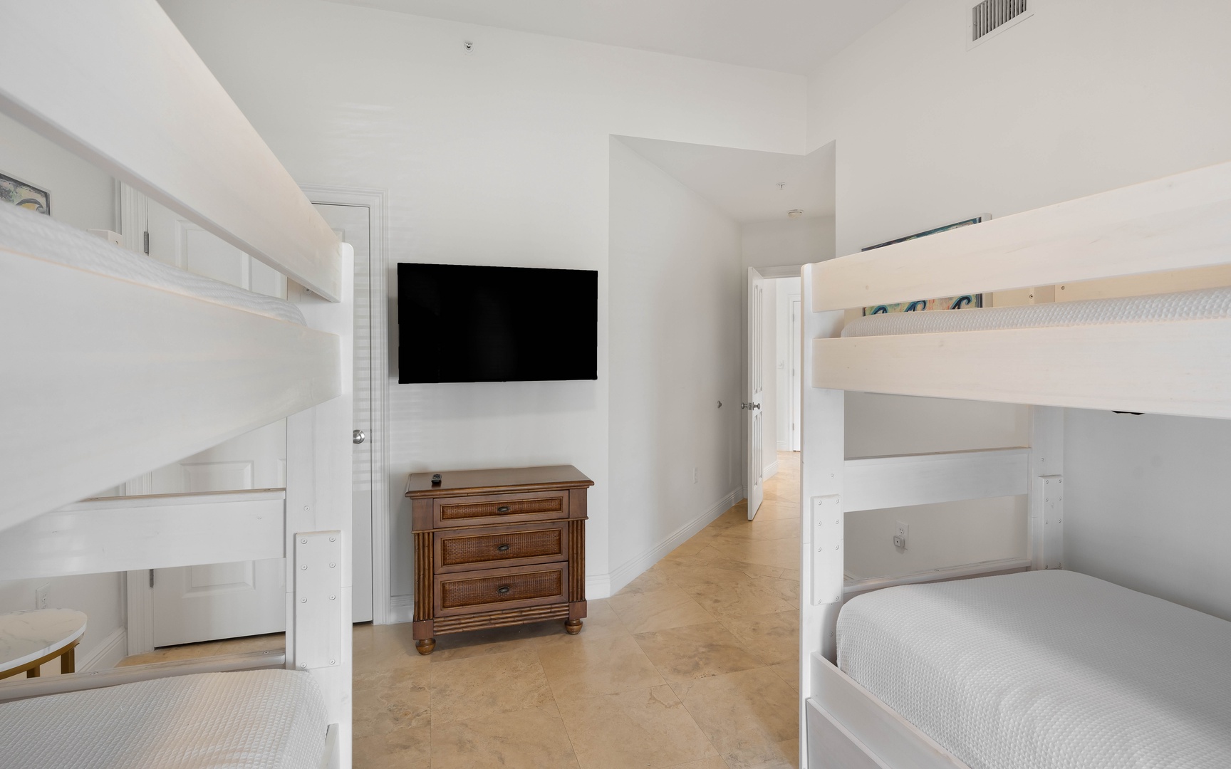 Your kids will love this bright bedroom with bunk beds, flat-screen TV, and plenty of space to play and relax together.