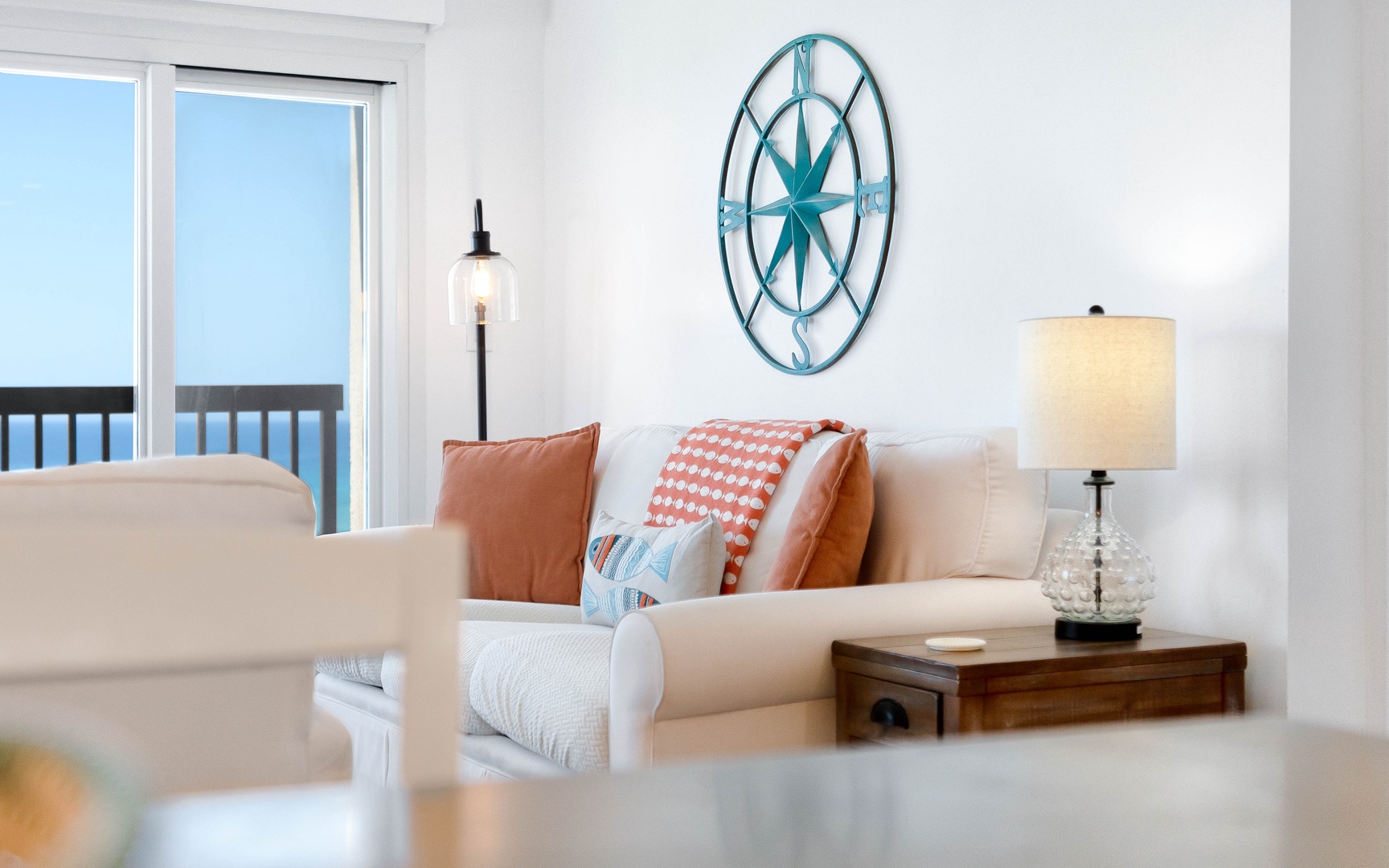 Sink into this coastal living room where ocean views meet comfort. Nautical touches and warm pillows create your perfect seaside retreat.