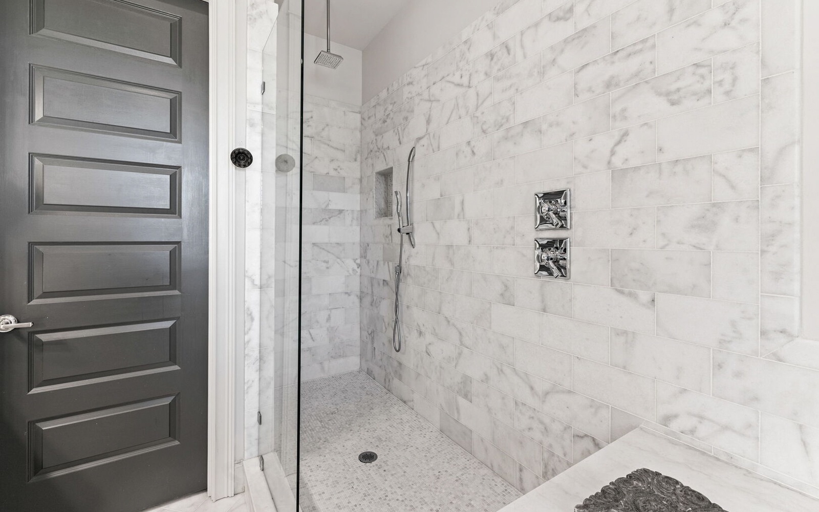 Step into your luxurious marble shower with rainfall head and built-in bench—your private spa retreat awaits.