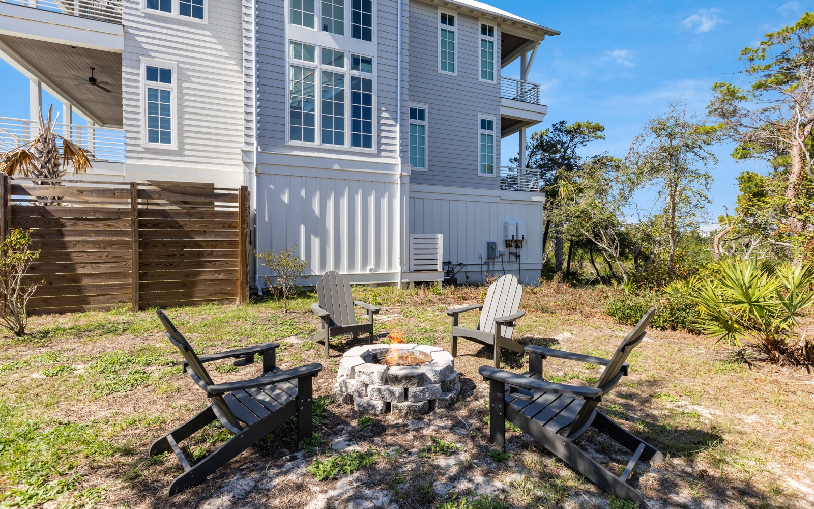 Gather around your private fire pit for cozy evenings under the stars, surrounded by comfortable Adirondack chairs in your own backyard retreat.