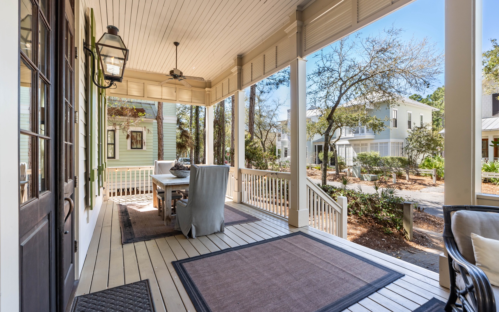 Step onto your private covered porch where comfortable seating awaits beneath ceiling fans, perfect for morning coffee or evening relaxation.