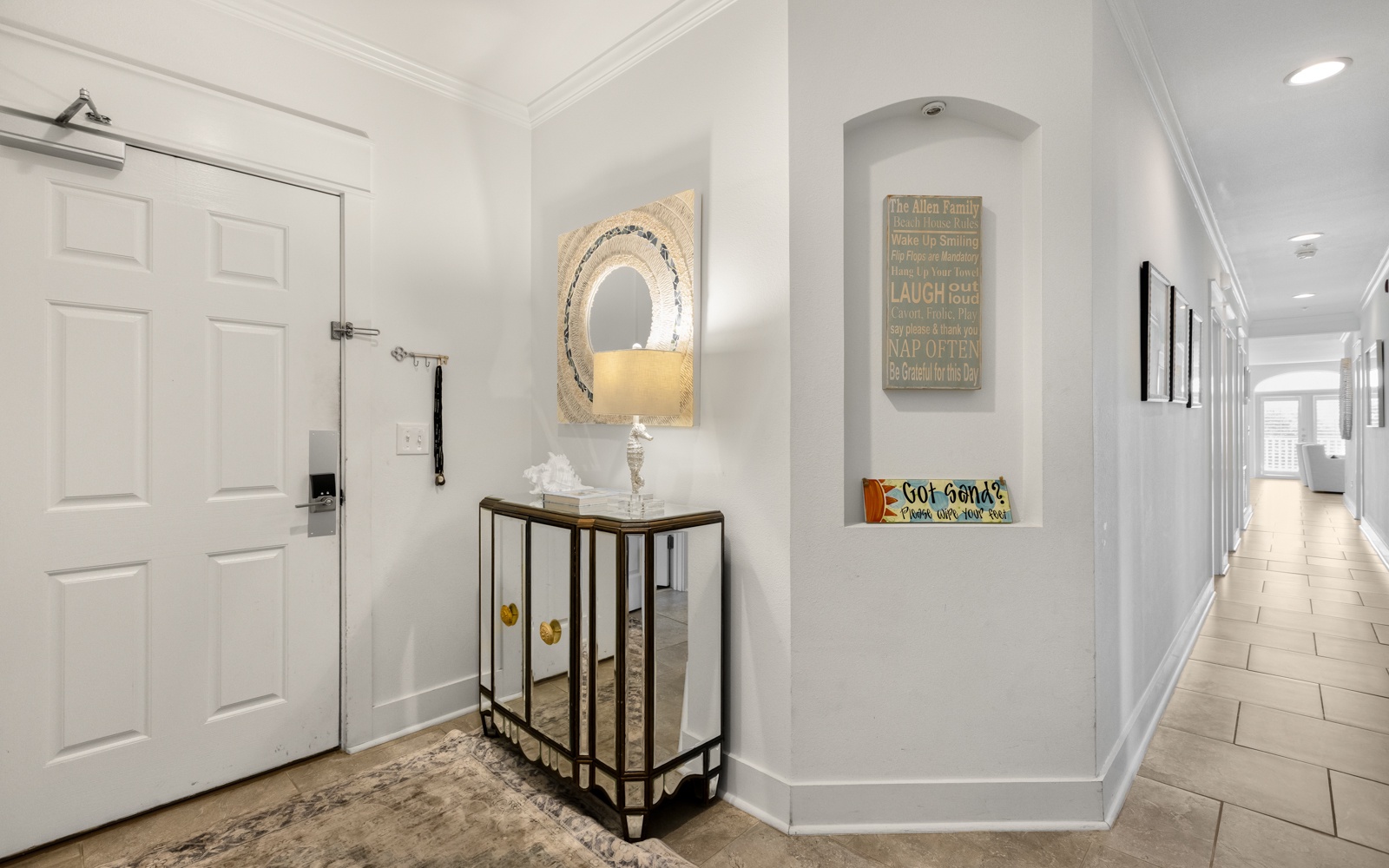 Step into your welcoming entry where coastal charm meets modern comfort, featuring thoughtful decor and bright, airy hallways.