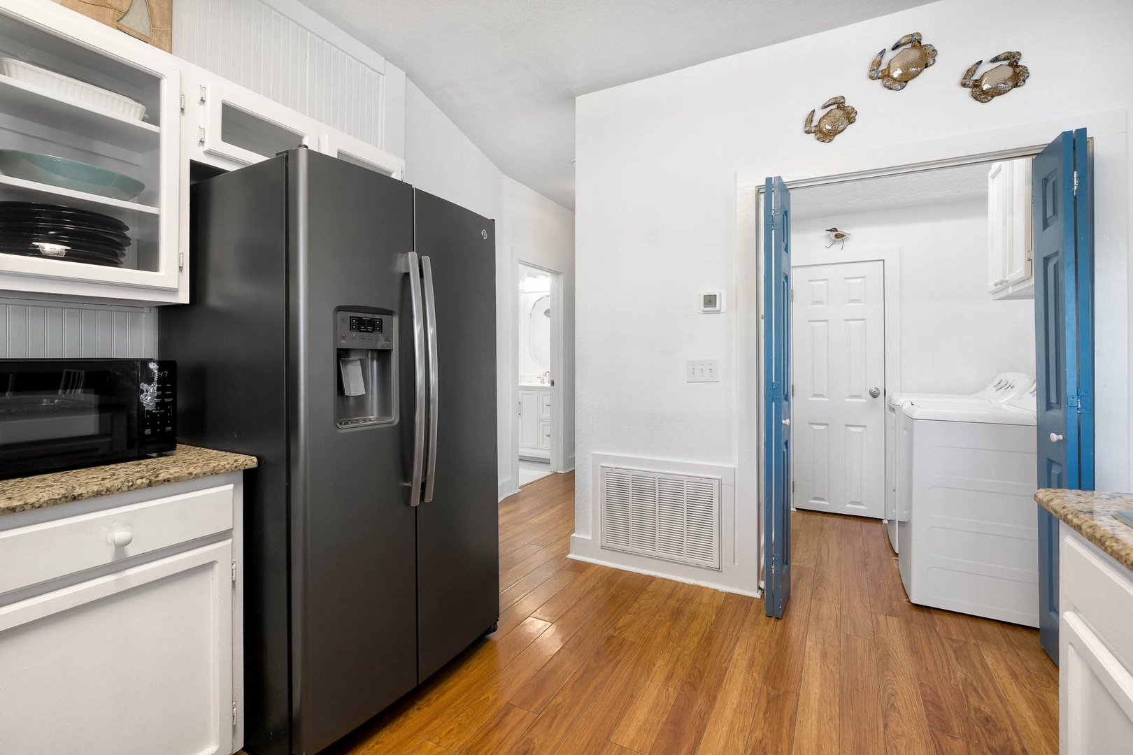 Your fully equipped kitchen features modern appliances and ample storage, with convenient laundry facilities just steps away for effortless meal prep and clean-up.