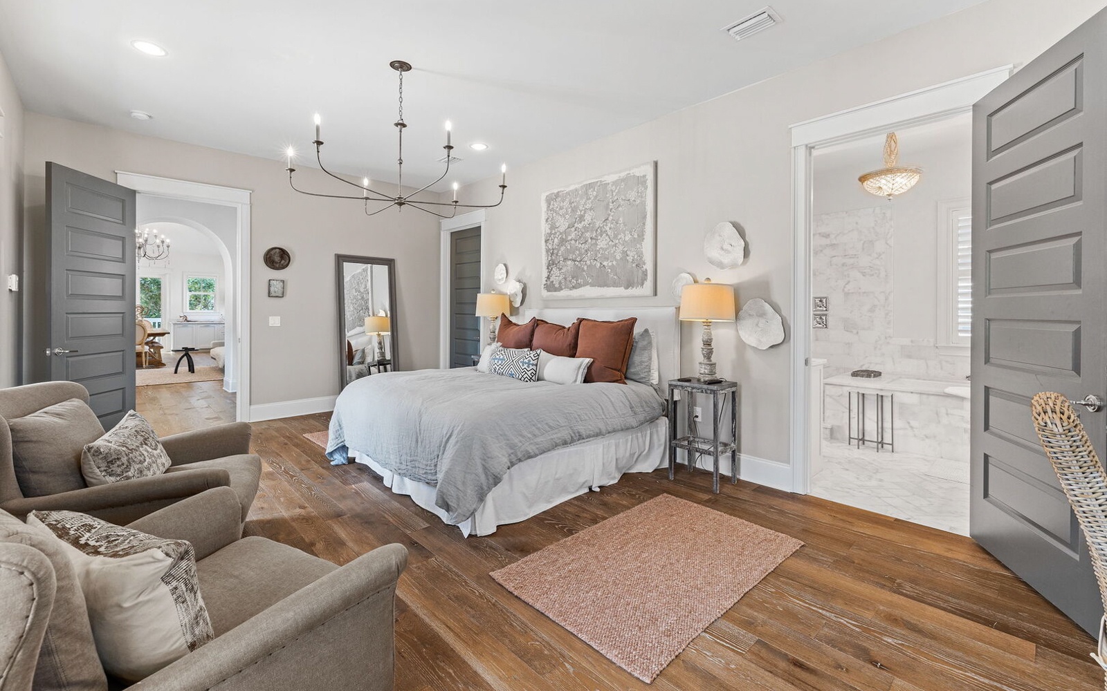 Retreat to your elegant master suite with plush seating, rich hardwood floors, and a luxurious ensuite bathroom for ultimate comfort.