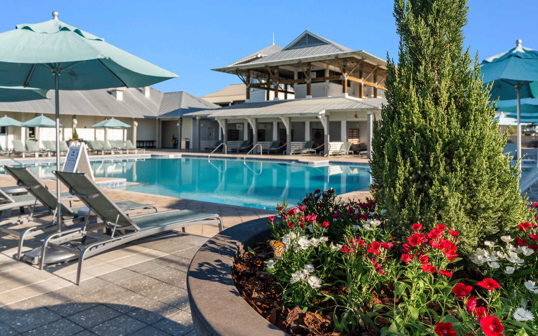 Sparkling pool and vibrant gardens create your perfect retreat. Lounge under turquoise umbrellas while soaking in the peaceful atmosphere.