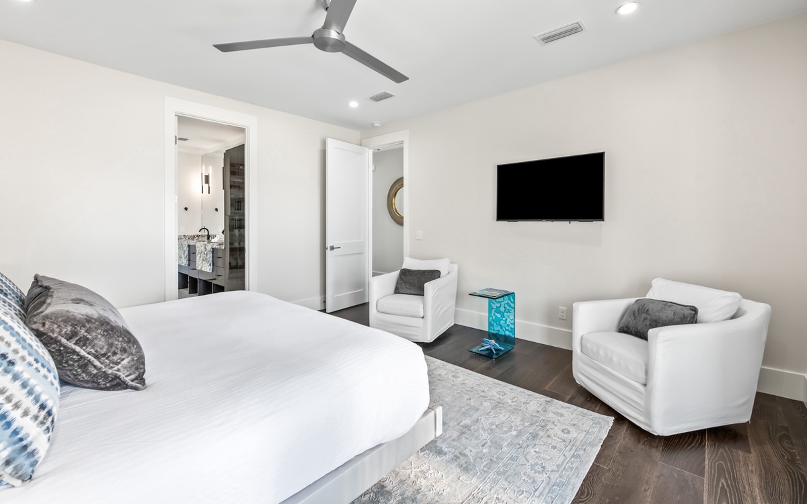 Unwind in your spacious suite with plush seating, wall-mounted TV, and cooling ceiling fan—perfect for relaxing after exploring.