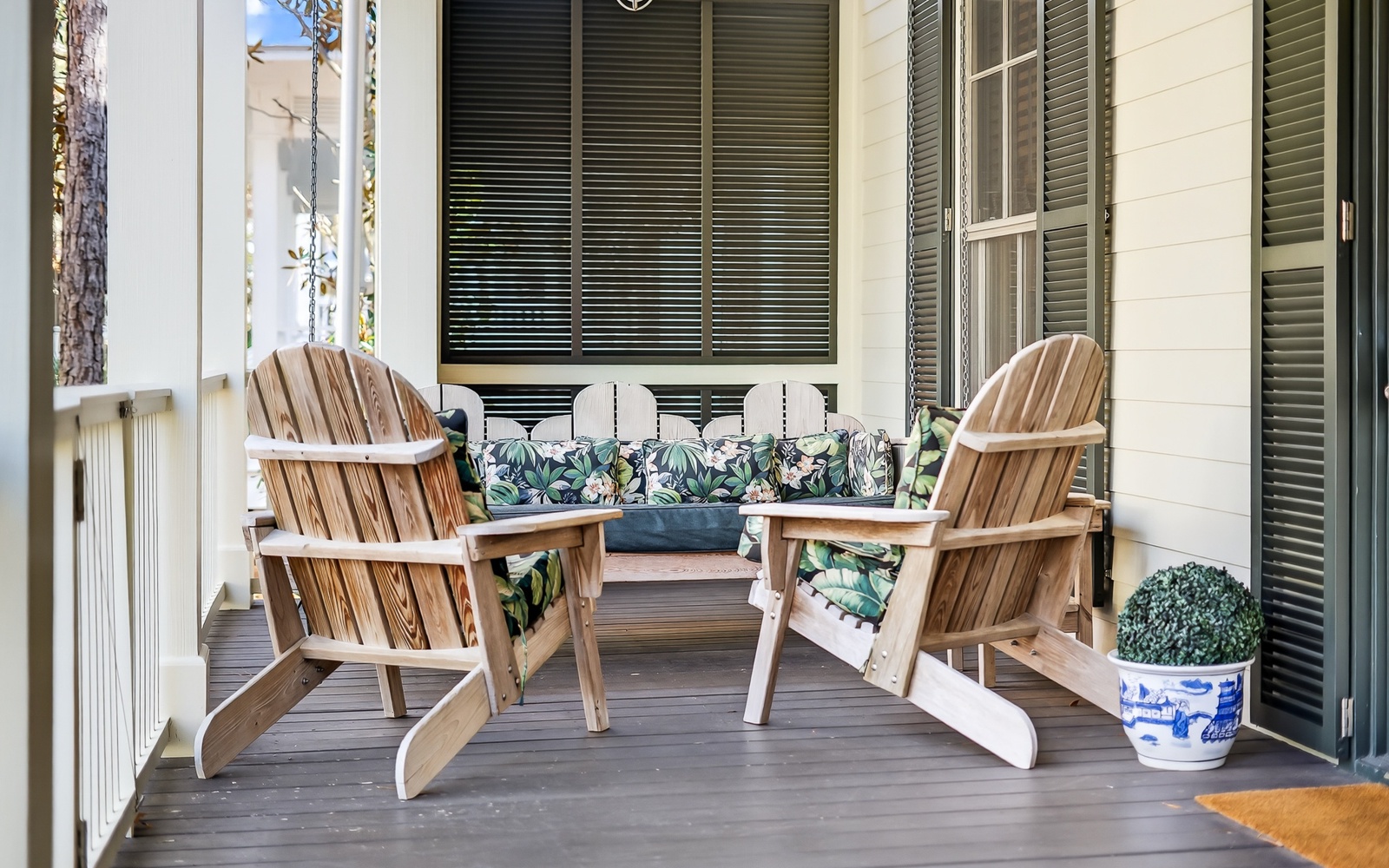 Relax on your private covered porch with comfortable Adirondack chairs and tropical-print cushions.