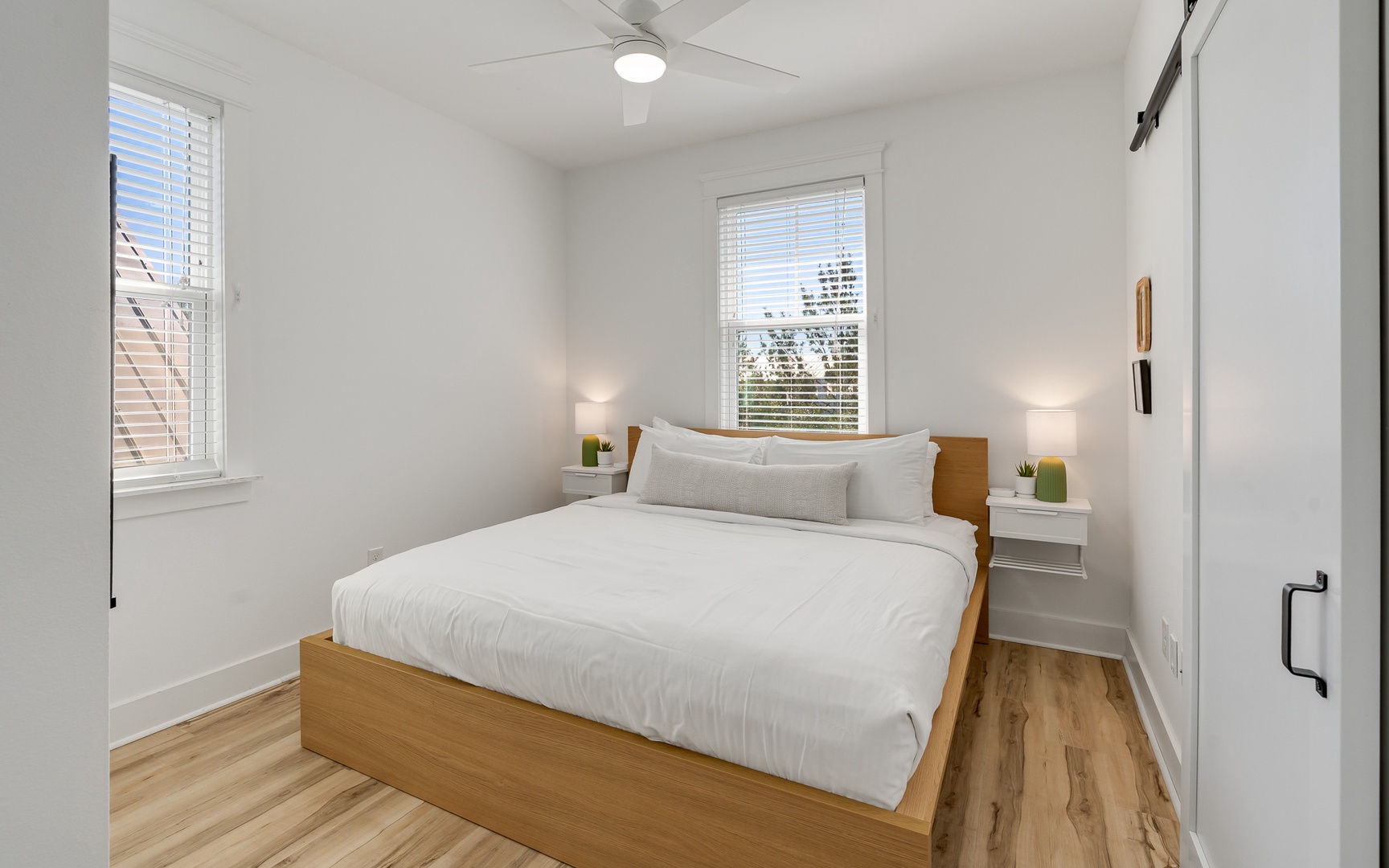 Drift off in your bright, airy bedroom with crisp linens and warm wood touches for the perfect night's rest.