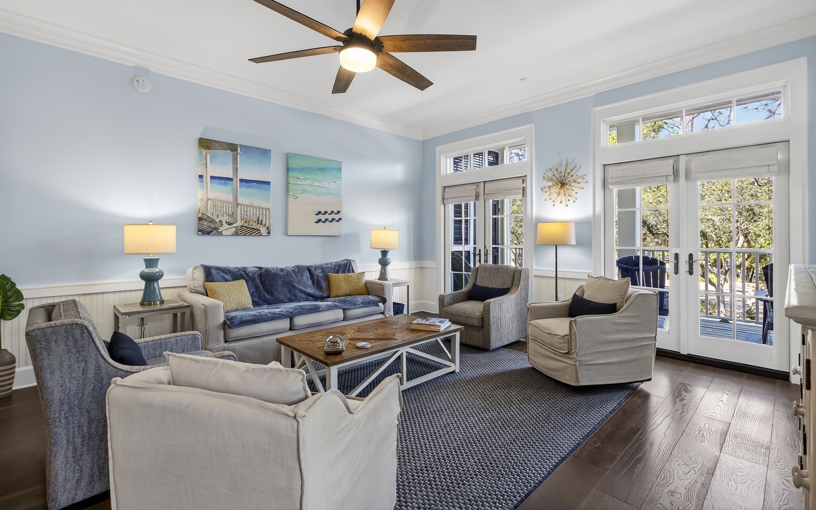 Relax in your beautifully appointed living room with coastal charm, plush seating, and French doors opening to your private balcony.