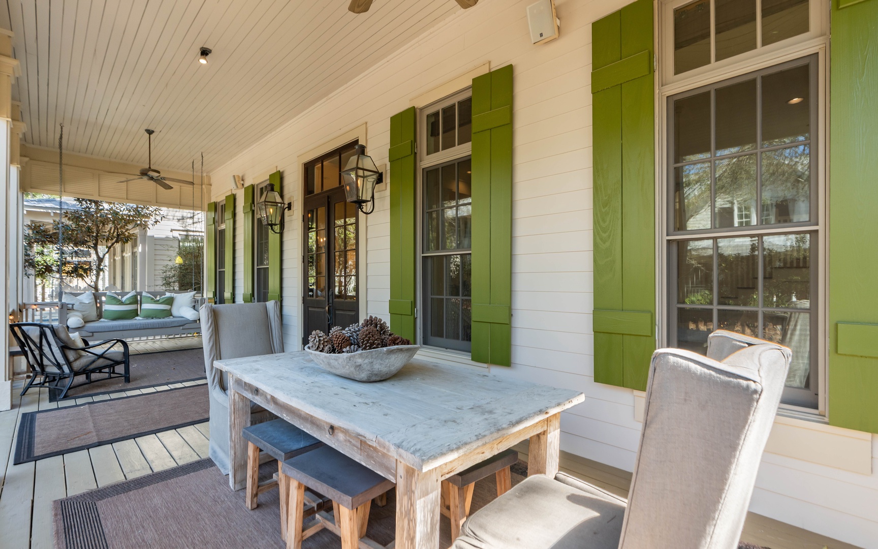 Settle into your private covered porch with rustic dining table and cozy seating, perfect for morning coffee or evening relaxation.