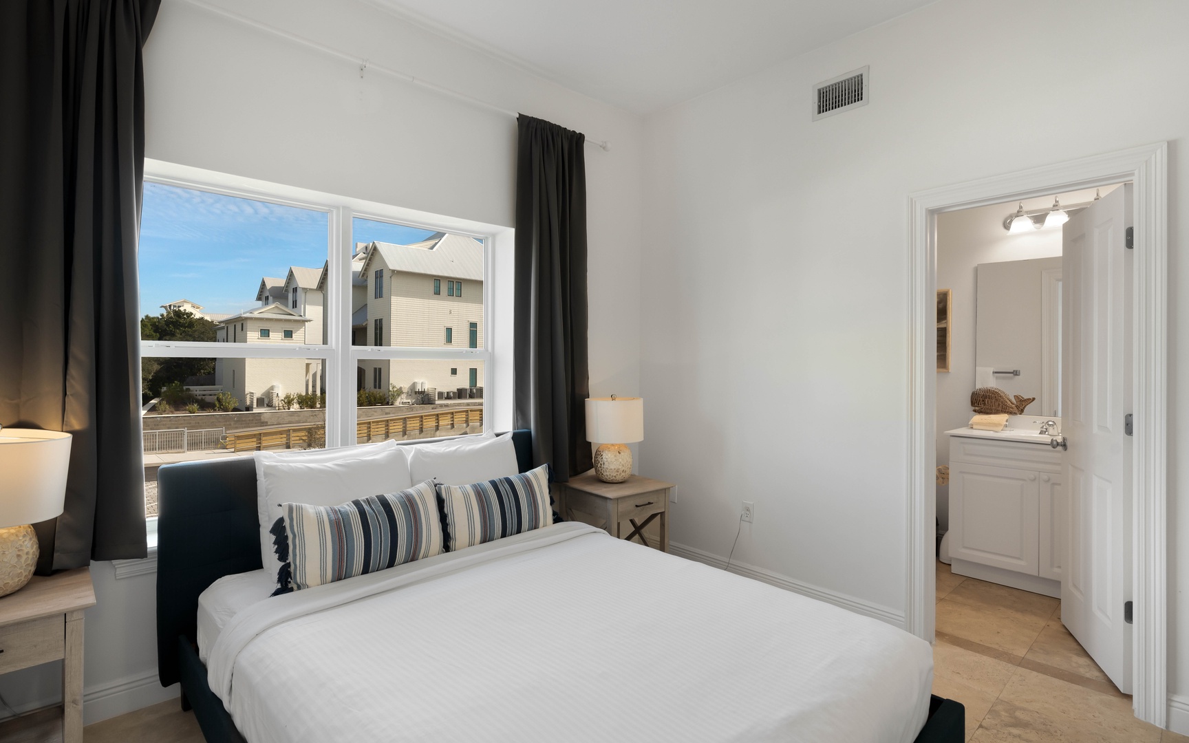 Wake up to bright seaside mornings in your serene bedroom, where crisp linens and ocean breezes create the perfect coastal retreat.