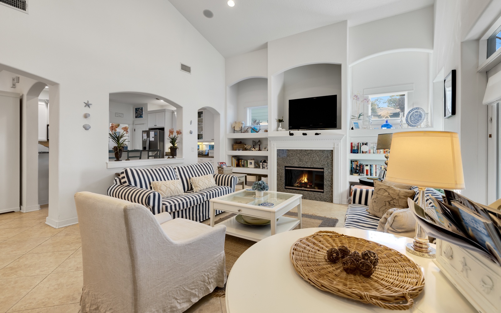 Unwind in your elegant living room with soaring arched ceilings, cozy fireplace, and thoughtfully arranged seating perfect for memorable gatherings.