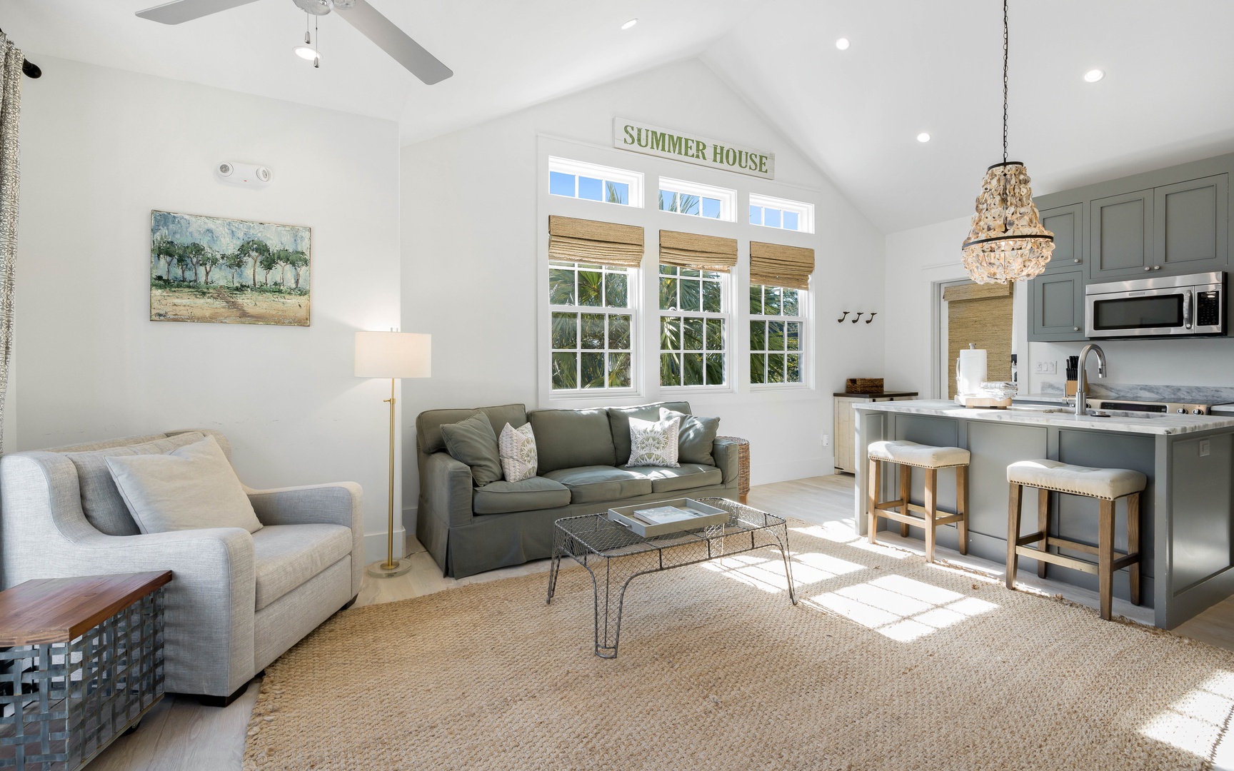 Sink into plush sofas in your bright, airy living space where natural light streams through charming windows, creating the perfect spot to unwind.