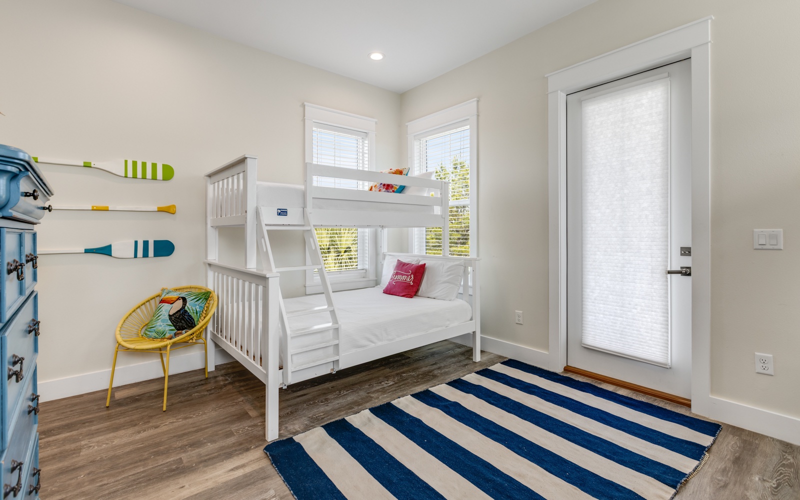 Your kids will love this cheerful bunk room with nautical touches and bright natural light streaming through dual windows.