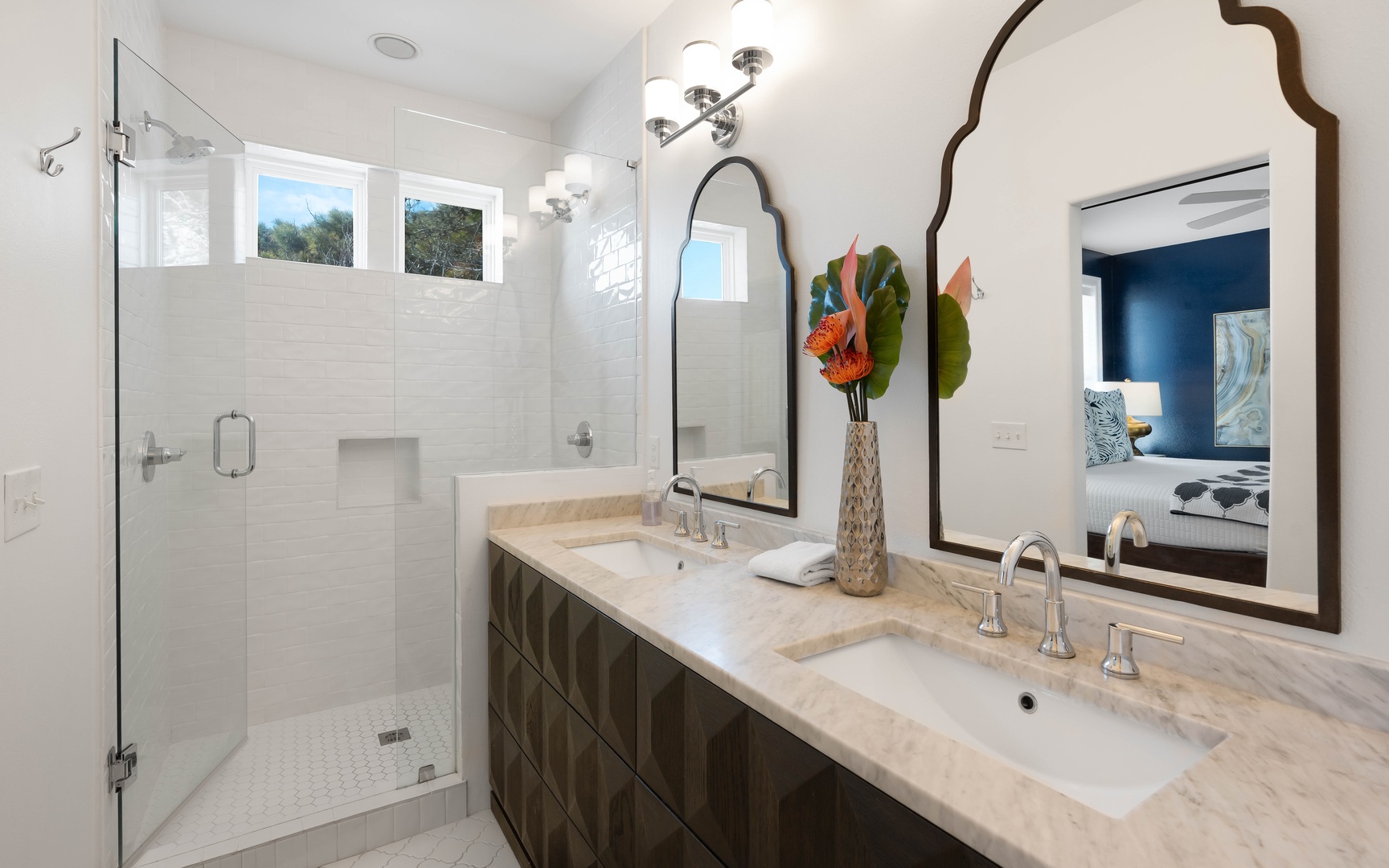 Indulge in your luxurious master bathroom featuring dual vanities, elegant marble countertops, and a spacious glass-enclosed shower for ultimate relaxation.
