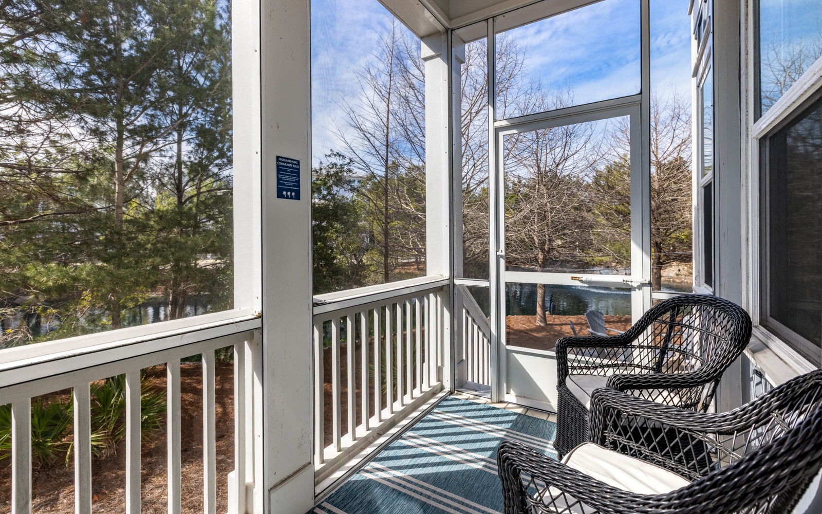 Step onto your screened porch where wicker chairs await your morning coffee, surrounded by peaceful tree views and natural light.