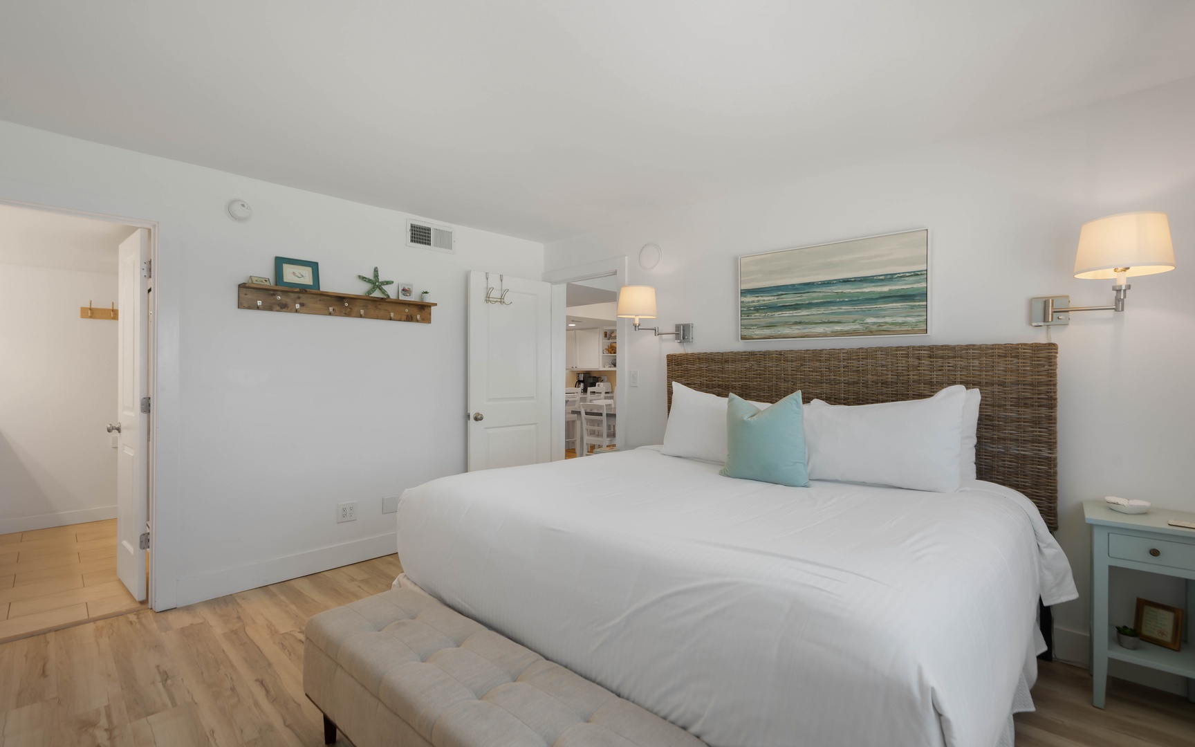 Drift off in your coastal-inspired bedroom with ocean artwork and soft linens creating the perfect beach getaway vibe.