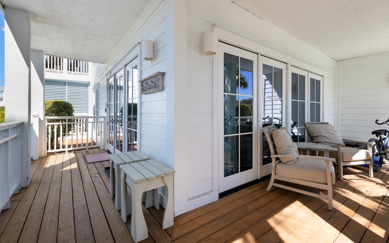 Step onto your private covered balcony and settle into comfortable lounge chairs surrounded by coastal charm and warm wood decking.