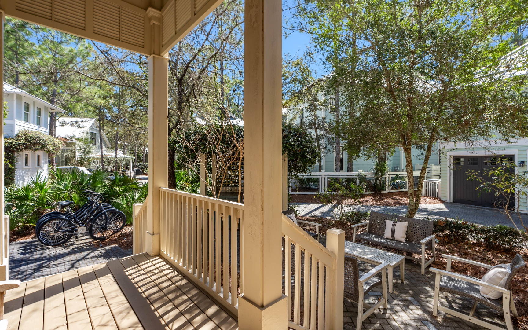 Your private balcony overlooking lush gardens and charming neighborhood homes, perfect for morning coffee or evening relaxation with nature's tranquil sounds.