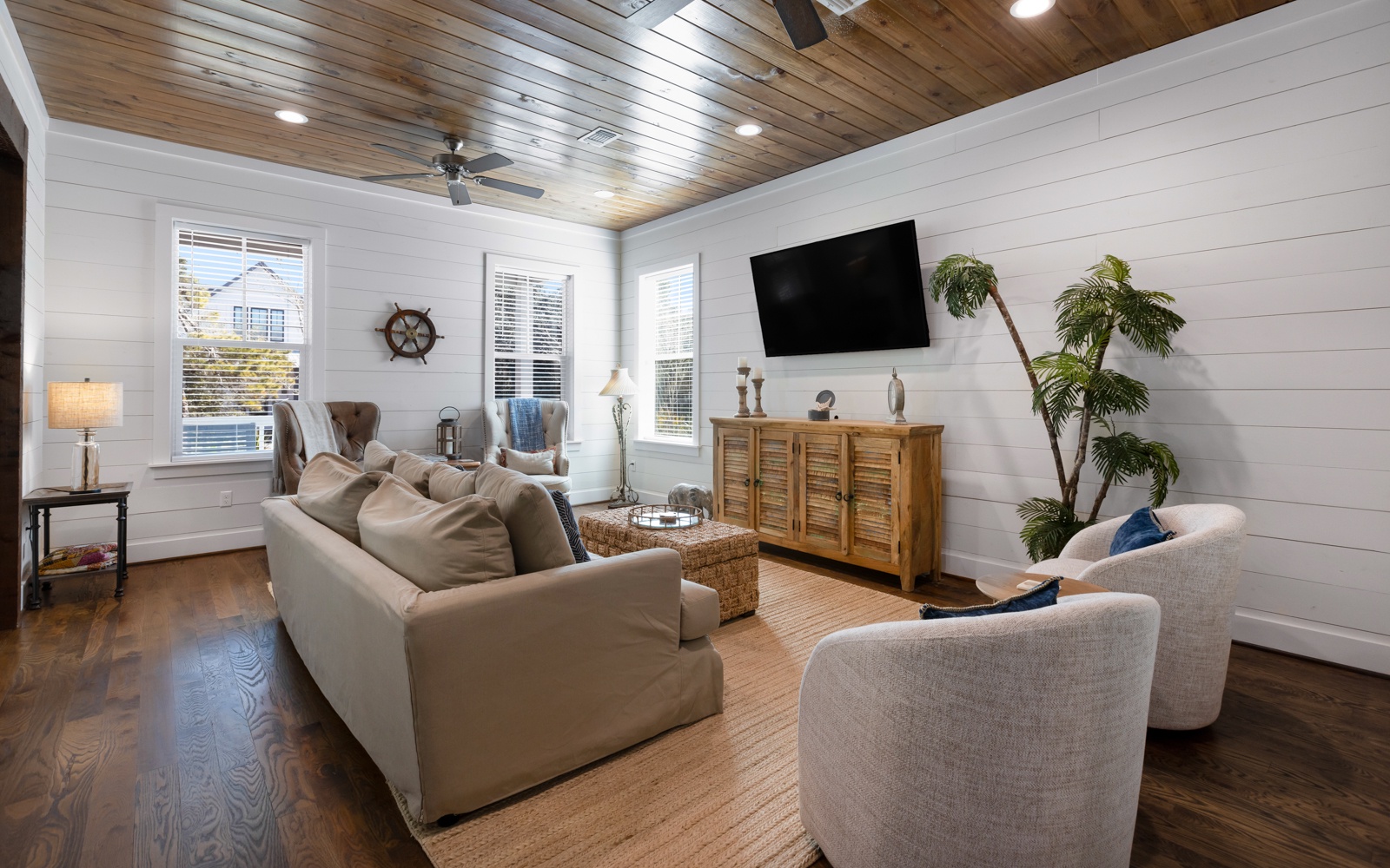 Unwind in your coastal-inspired living space with soaring wood ceilings, plush seating, and nautical touches that create the perfect retreat.