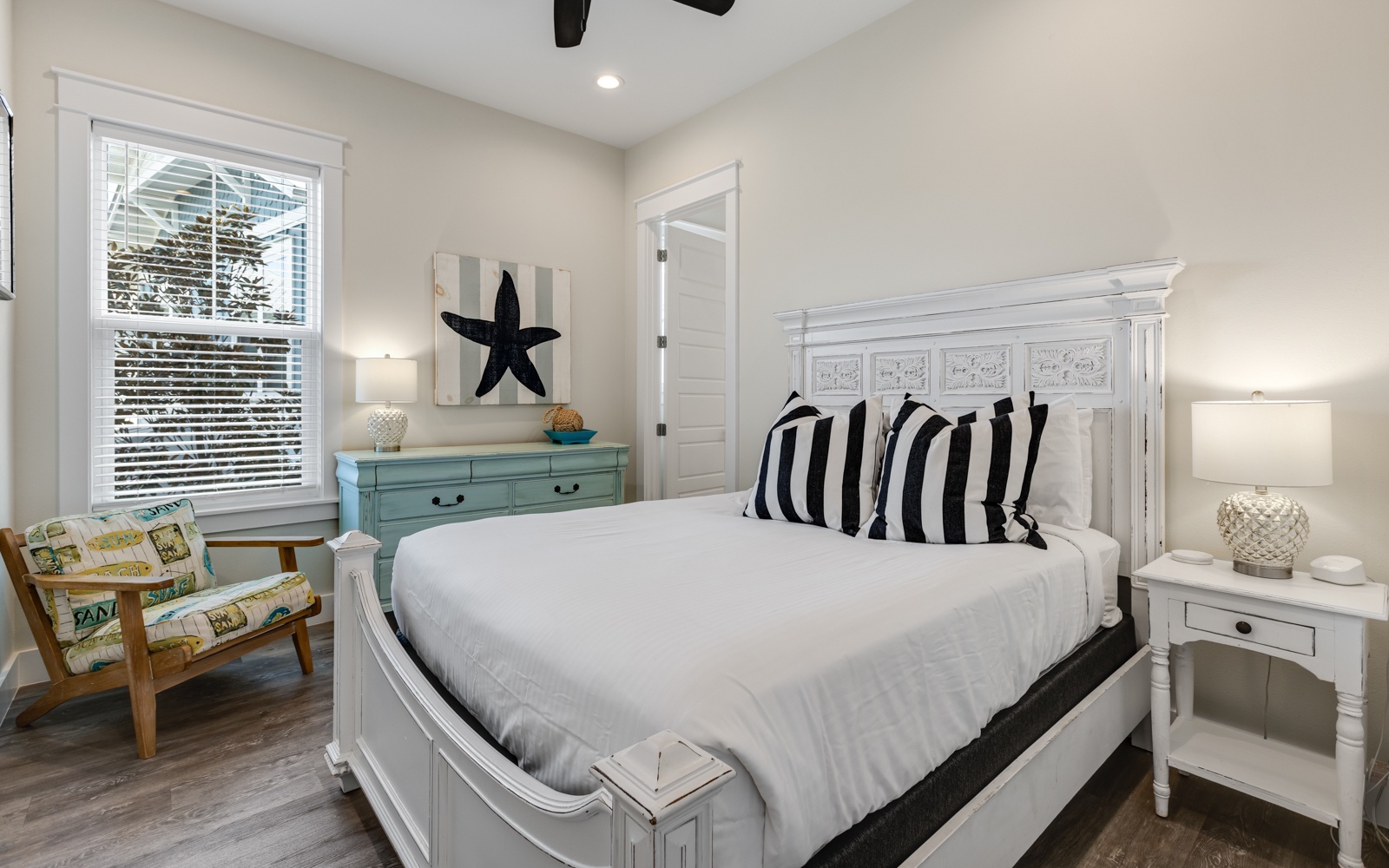 Sink into crisp white linens and nautical charm in your coastal-themed bedroom, where comfort meets style perfectly.