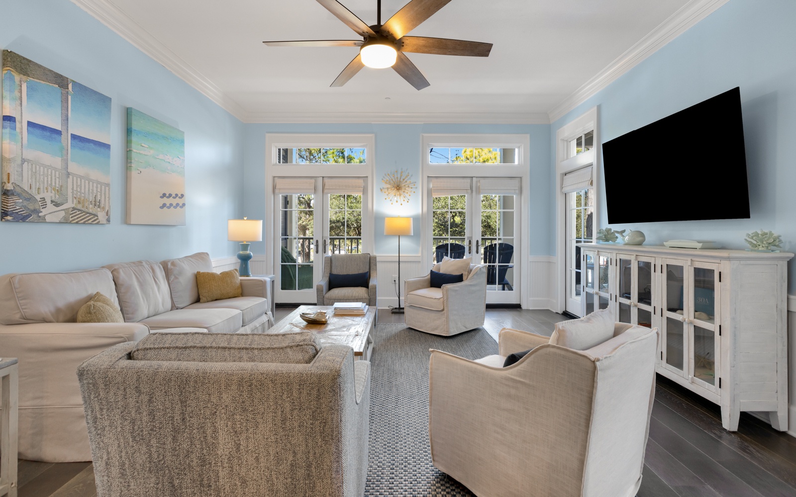 Settle into this bright, airy living room where coastal charm meets comfort. Plush seating and calming blues create your perfect relaxation retreat.