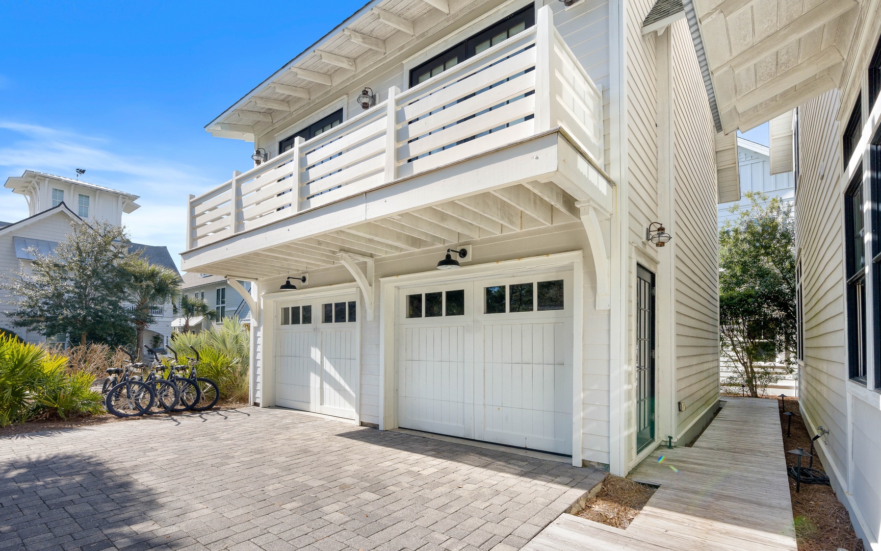 Coastal-style vacation home with convenient garage parking and bike storage for easy beach adventures.