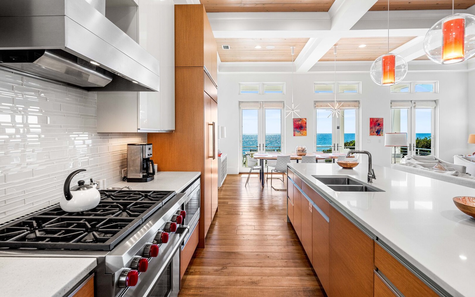 Cook gourmet meals in your modern kitchen while enjoying stunning ocean views through expansive windows.