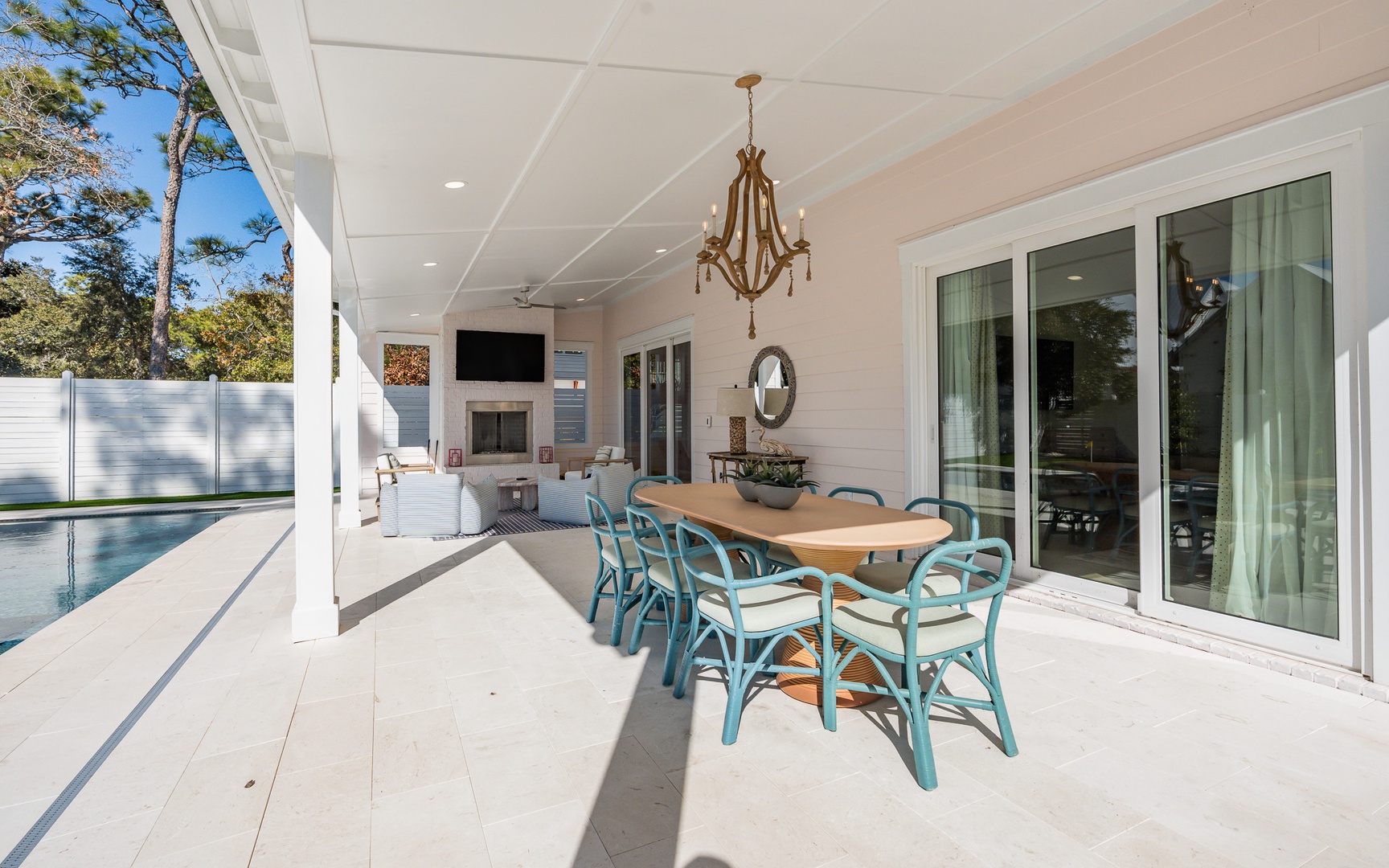 Relax under your covered terrace with elegant dining for eight, overlooking the sparkling pool and peaceful garden views.