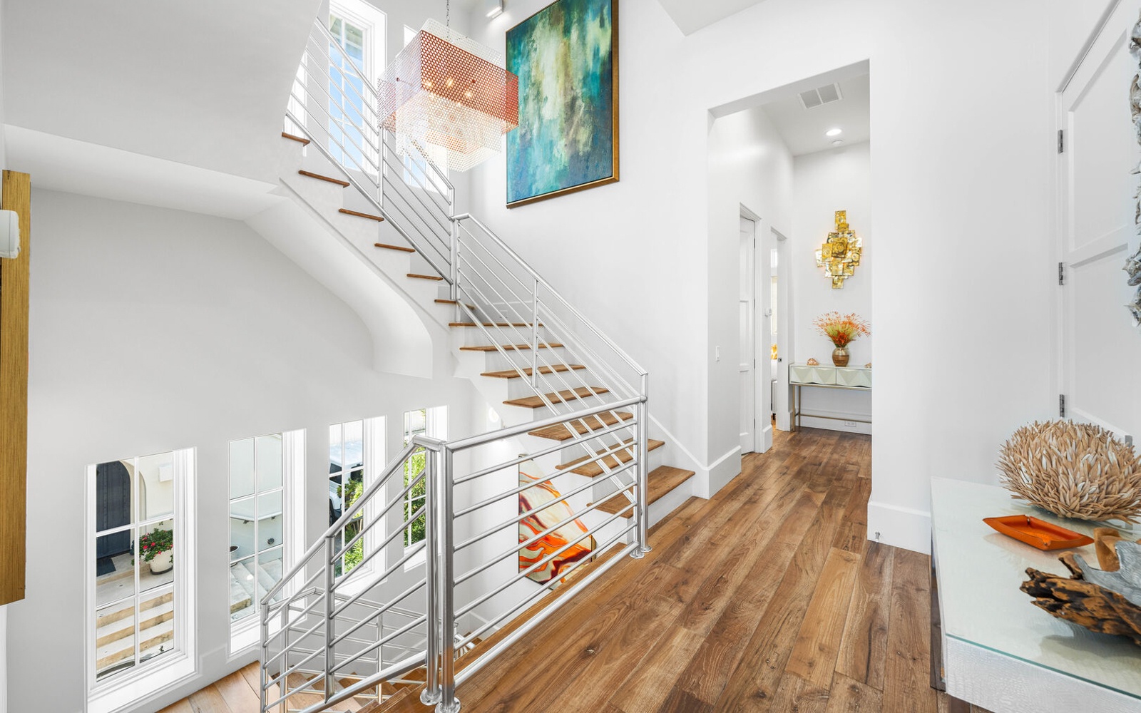 Step into your bright, modern retreat where sleek stairs and warm wood floors create an inviting atmosphere for your perfect getaway.