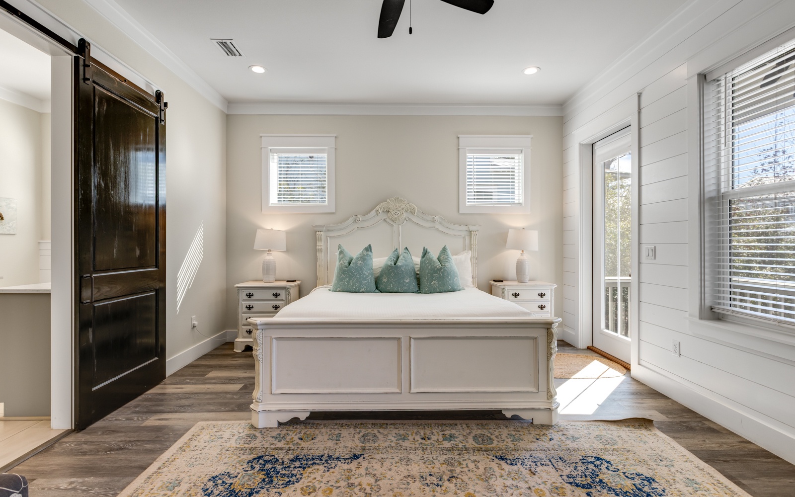 Drift into peaceful dreams in your elegant bedroom sanctuary, featuring coastal-inspired touches and charming barn door details.