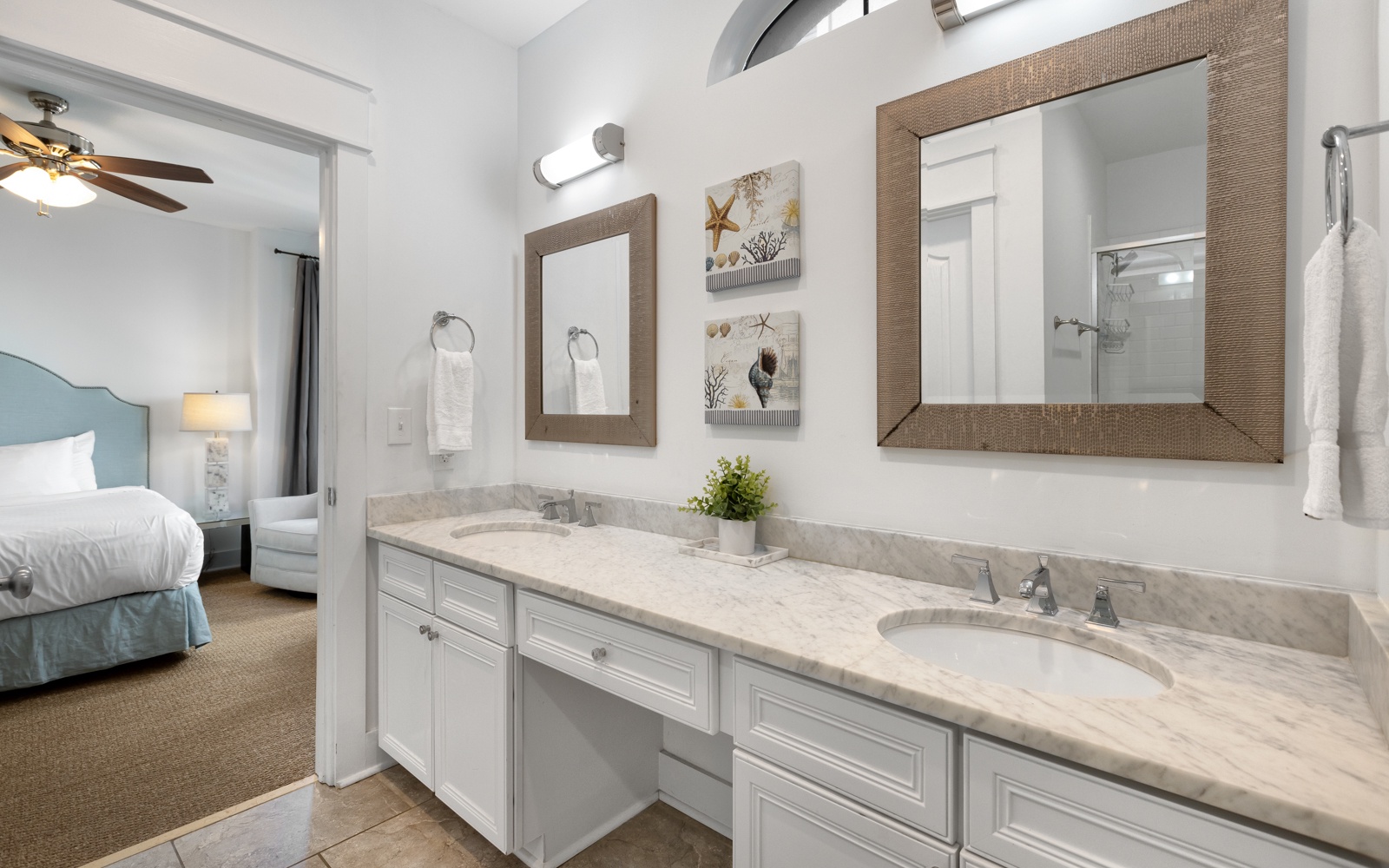 Refresh in your elegant ensuite with dual vanities, marble countertops, and coastal charm—perfectly connected to your peaceful bedroom retreat.