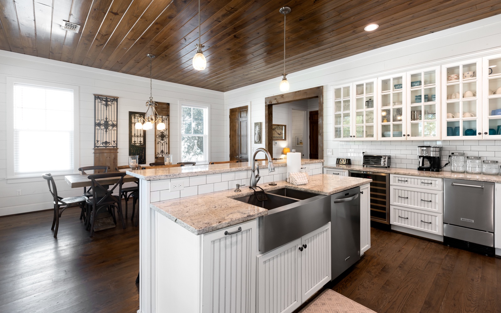 Your gourmet kitchen awaits with granite countertops, farmhouse sink, and rustic wood ceiling creating the perfect space for memorable meals.
