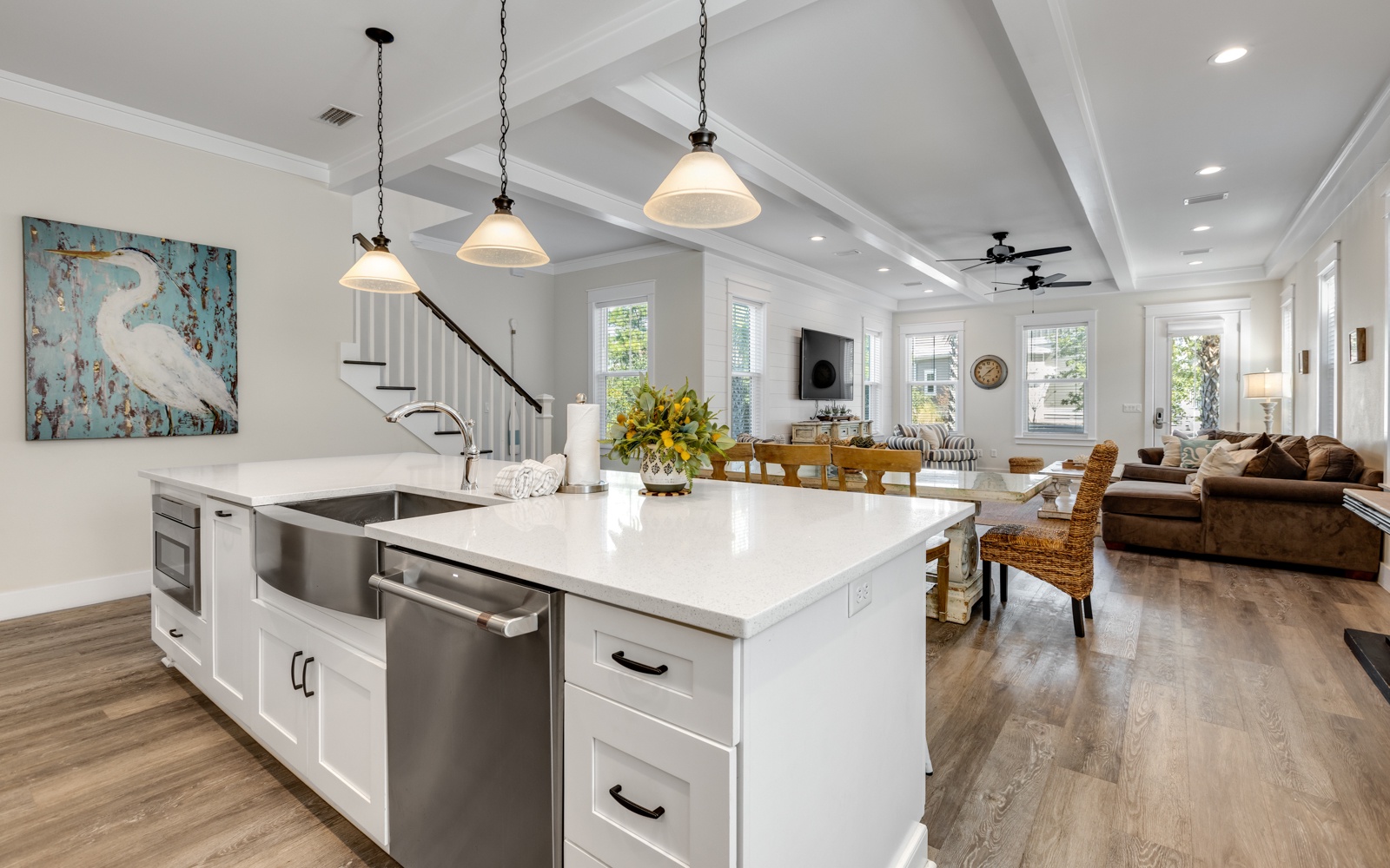 Step into your bright, modern sanctuary where gleaming white counters invite morning coffee preparation and evening meal gatherings.