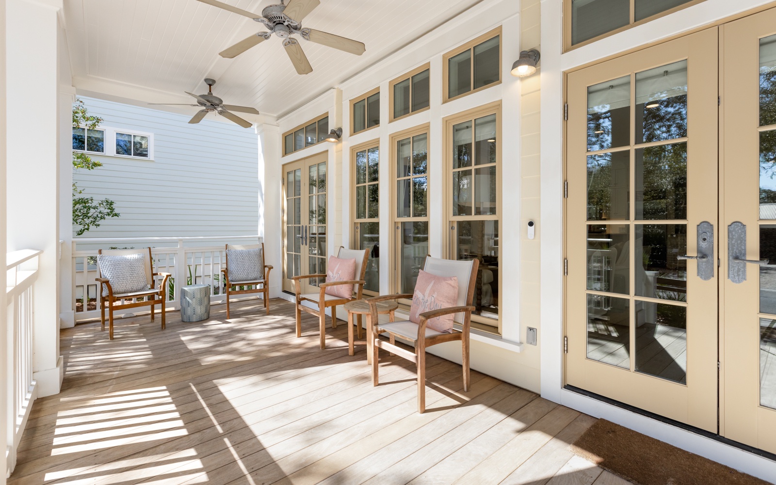 Unwind on your private covered porch with comfortable seating, gentle ceiling fans, and French doors opening to your peaceful retreat.
