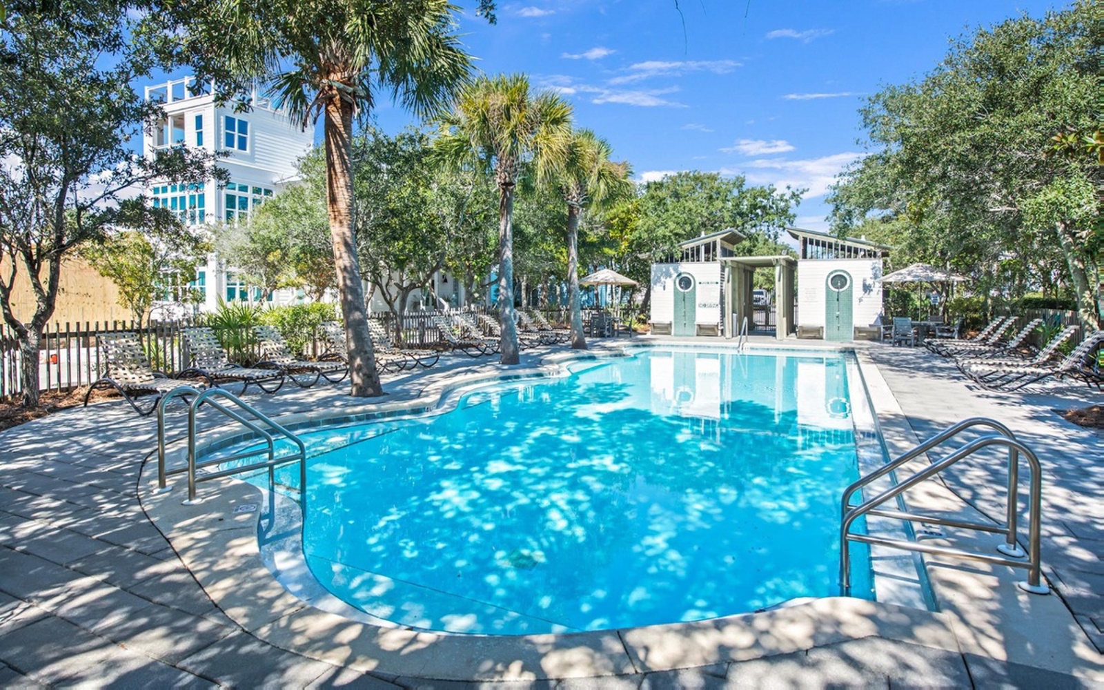 Resort-style pool area with tropical landscaping and modern facilities creating an inviting community space for relaxation.