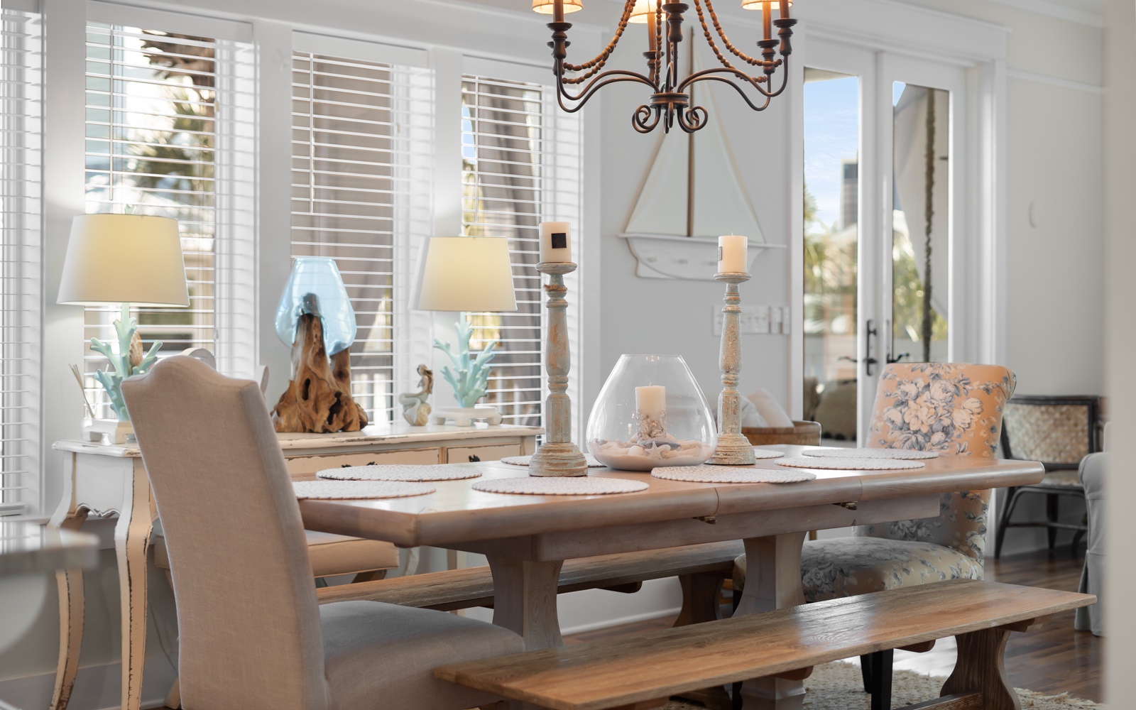 Gather around this elegant dining table where every meal feels like a special occasion with beautiful chandelier lighting.