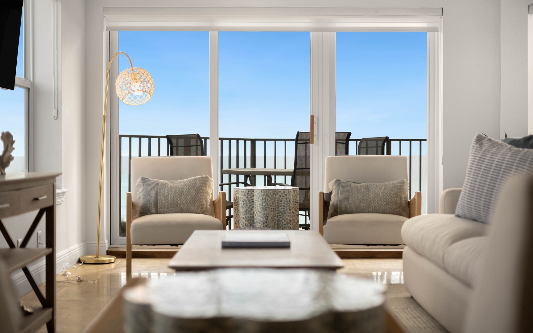 Unwind in your bright living room where soft seating and golden lighting create the perfect retreat after exploring.