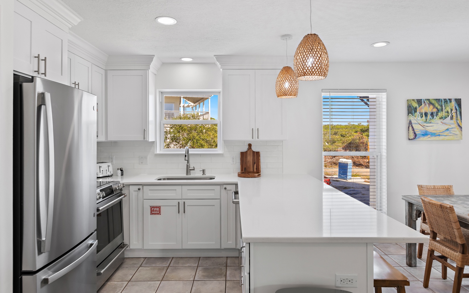 Your bright, modern kitchen features stainless steel appliances and opens to serene outdoor views, perfect for preparing meals in paradise.