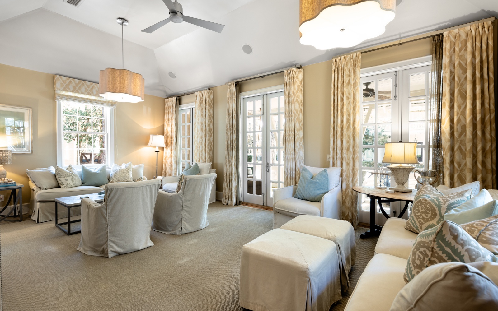 Sink into plush seating where elegant gold curtains frame natural light, creating your perfect retreat for relaxation and conversation.