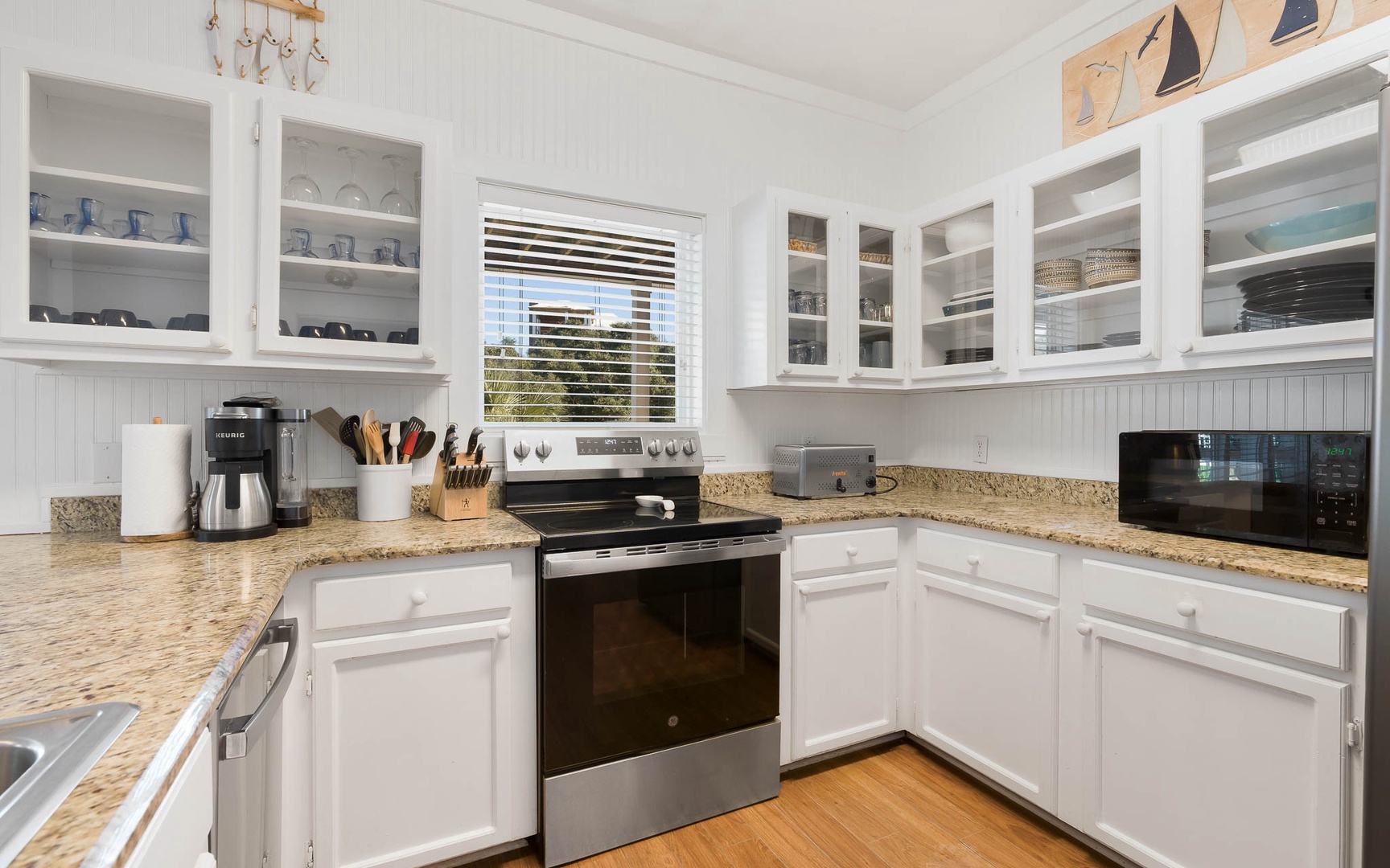 Your fully equipped kitchen features granite counters, glass-front cabinets, and everything needed to create memorable meals during your stay.